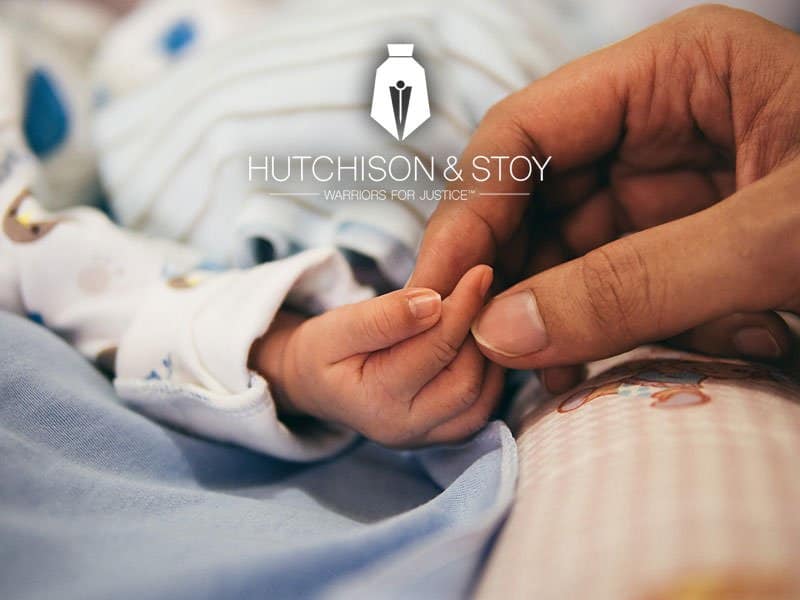 Nurse holding a baby hand